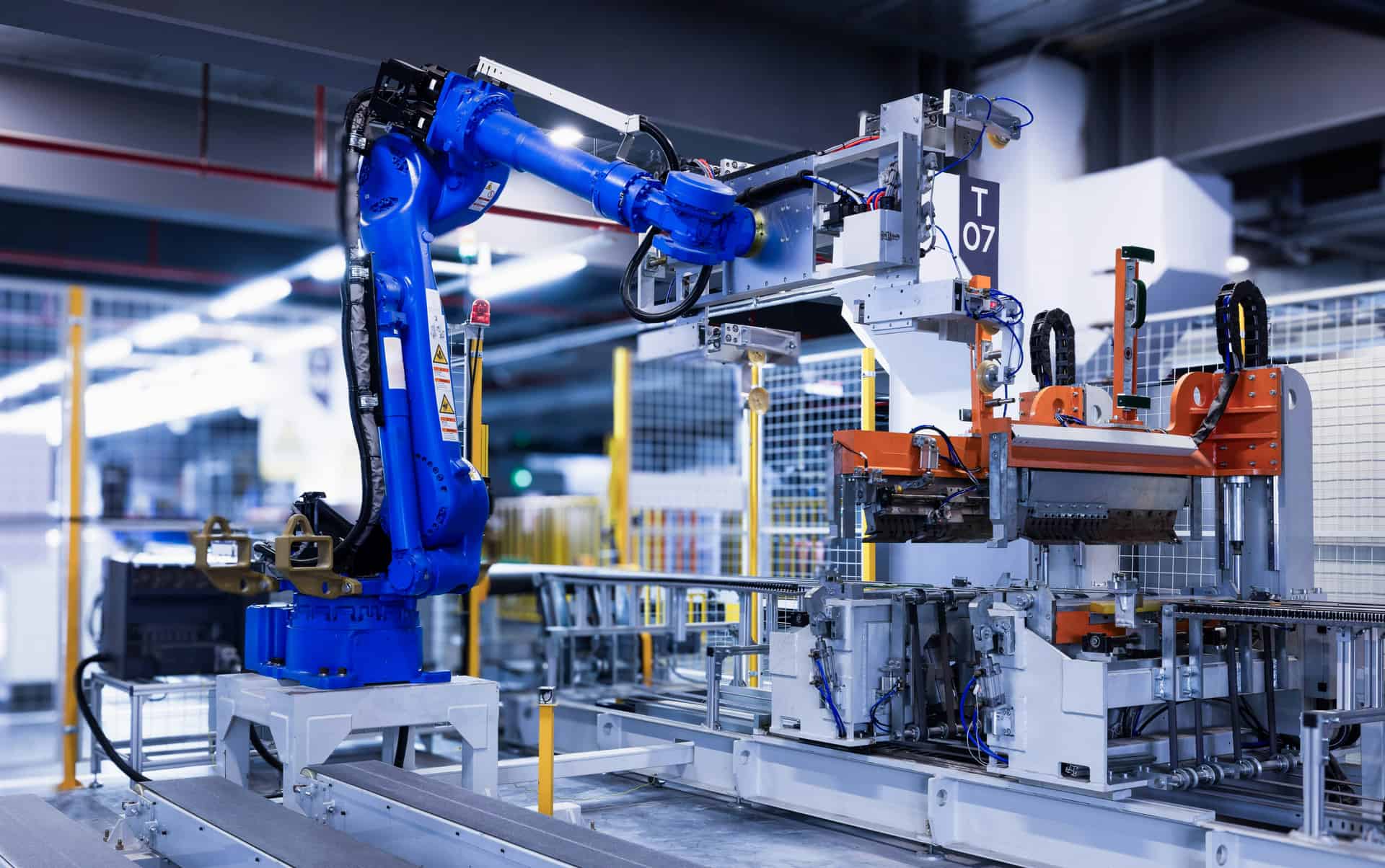Blue industrial robot arm in an automation cell